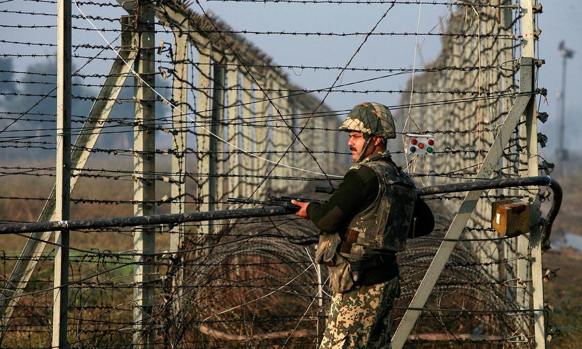 an indian border security force soldier patrols the fenced border with pakistan in suchetgar photo reuters