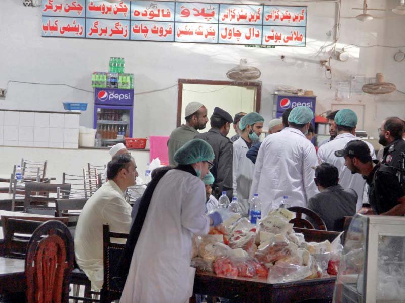 sindh food authority officials collect samples from naubahar restaurant where the ill fated family got their dinner on thursday night photo ppi