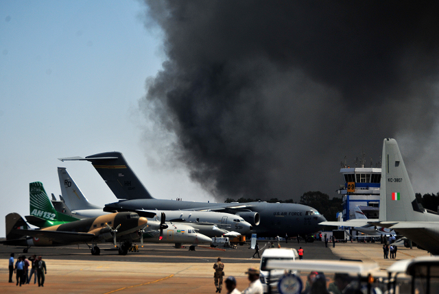 smoke billows past a row of parked planes after a fire broke out in a parking lot during the aero india show at the yelahanka air force station in bengaluru india february 23 2019 photo reuters