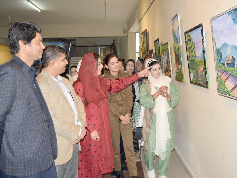 visitors including parliamentary secretary shazia rizwan and chief traffic police officer beenish fatima admire the artworks of painter shanze noreen each of her paintings present different renditions of a serene pastoral countryside photo express