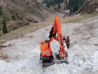 workers use machinery to cut through glaciers on the road to lake saiful malook to reopen it for traffic photo express