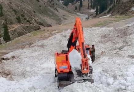 workers use machinery to cut through glaciers on the road to lake saiful malook to reopen it for traffic photo express