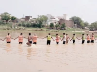 divers search for a youth feared drowned in a stream in narowal authorities have warned residents to avoid going near watercourses during the monsoon season photo nni