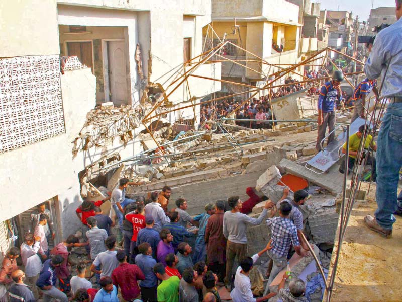 local residents and rescue workers sift through the rubble looking for survivors after a three storey building collapsed in malir on monday morning photo ppi