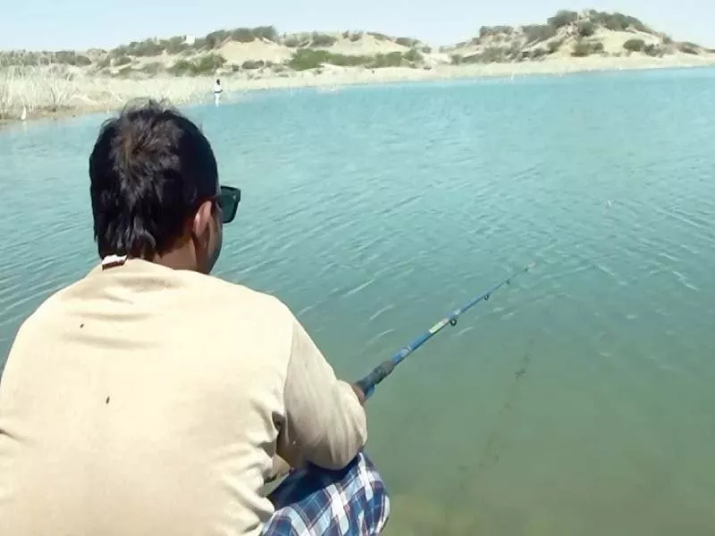 a man casts his fishing line at the hub dam with the rise in water level the dam has become a picnic attraction photo express a man casts his fishing line at the hub dam with the rise in water level the dam has become a picnic attraction photo express