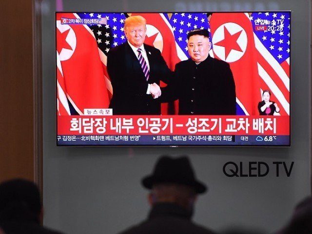 a television screen shows a news broadcast of north korea 039 s leader kim jong un shaking hands with us president donald trump during their first meeting in hanoi photo afp a television screen shows a news broadcast of north korea 039 s leader kim jong un shaking hands with us president donald trump during their first meeting in hanoi photo afp