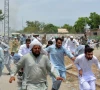 protesters run as gunfire broke out during a protest after the recent suicide attack by militants on an army enclave in bannu on july 19 photo afp