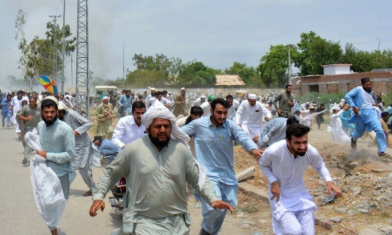 protesters run as gunfire broke out during a protest after the recent suicide attack by militants on an army enclave in bannu on july 19 photo afp