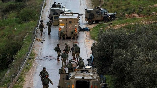 israeli forces gather at the scene of an incident near ramallah in the israeli occupied west bank photo reuters israeli forces gather at the scene of an incident near ramallah in the israeli occupied west bank photo reuters