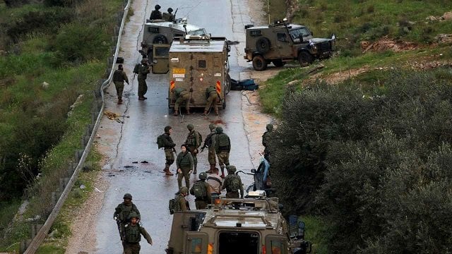 israeli forces gather at the scene of an incident near ramallah in the israeli occupied west bank photo reuters