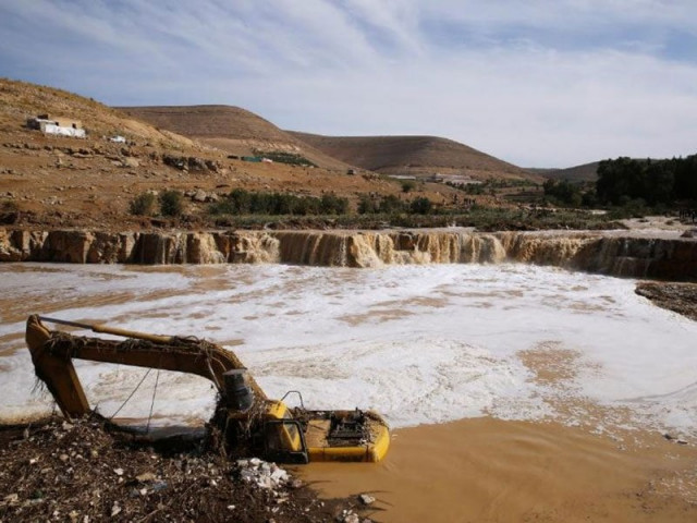 an excavator is partially submerged in a stream after rain storms unleashed flash floods in madaba city near amman jordan november 10 2018 photo reuters