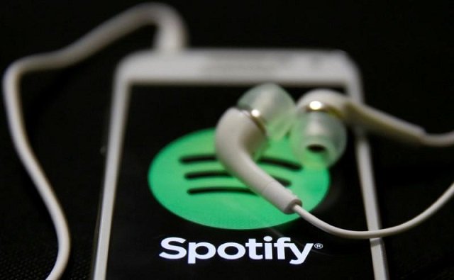 earphones are seen on top of a smart phone with a spotify logo on it in this february 20 2014 photo illustration photo reuters