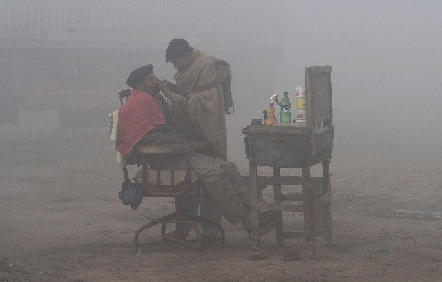 files in this file photo taken on january 24 2019 a pakistani barber shaves a customer alongside a road amid heavy fog and smog conditions in lahore photo afp files in this file photo taken on january 24 2019 a pakistani barber shaves a customer alongside a road amid heavy fog and smog conditions in lahore photo afp