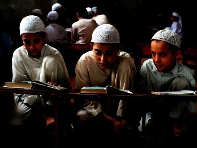 children reading at an islamic seminary in pakistan photo express file