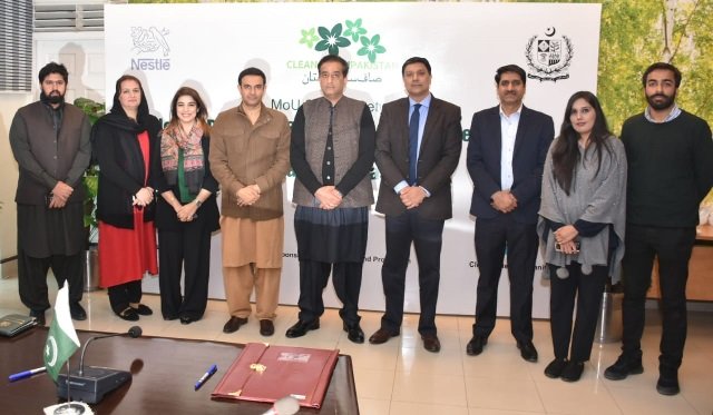 waqar ahmed head of corporate affairs nestle pakistan malik amin aslam adviser to the prime minister on climate change and other officials after signing an mou for the 039 clean green pakistan movement 039 photo express