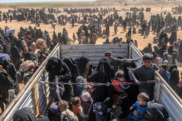 civilians evacuated from the islamic state is group 039 s embattled holdout of baghouz wait at a screening area held by the us backed kurdish led syrian democratic forces sdf in the eastern syrian province of deir ezzor on march 6 2019 photo afp