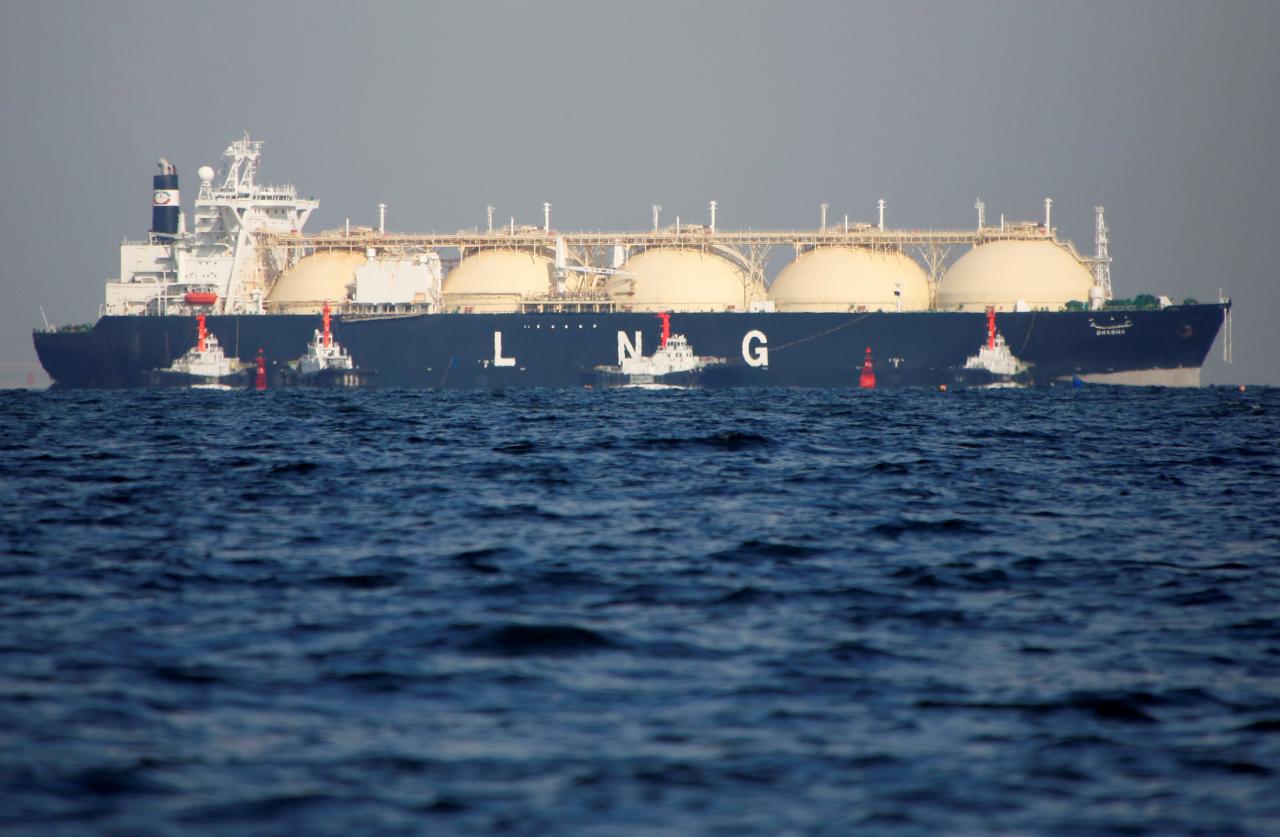 a liquefied natural gas lng tanker is tugged towards a thermal power station photo file