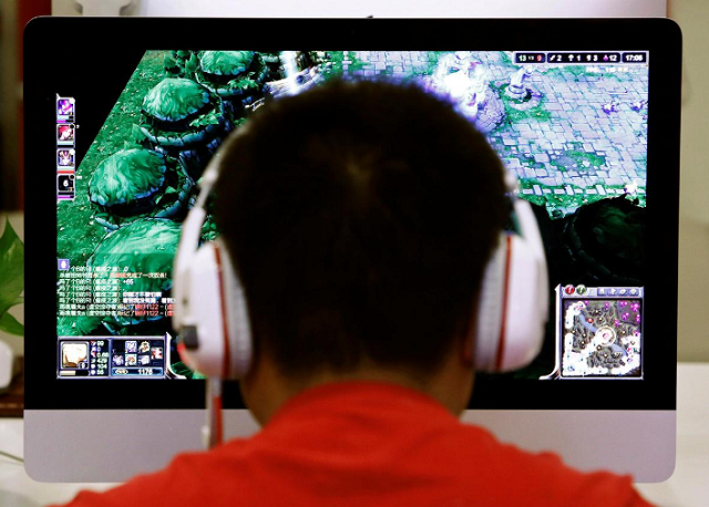 a man plays a computer game at an internet cafe in beijing china may 9 2014 photo reuters a man plays a computer game at an internet cafe in beijing china may 9 2014 photo reuters