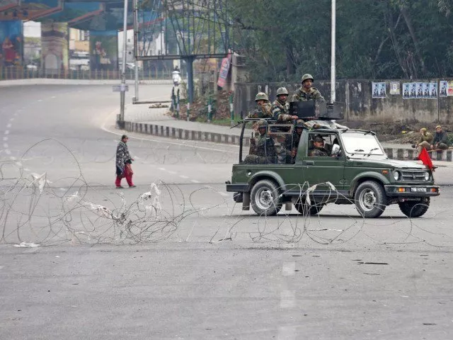 indian soldiers in a vehicle patrol a street as a woman walks past during a curfew in occupied kashmir photo reuters file indian soldiers in a vehicle patrol a street as a woman walks past during a curfew in occupied kashmir photo reuters file