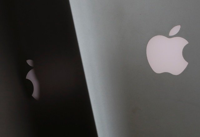 apple company logos are seen as two macbooks stand next to each other in an office in vienna austria january 3 2019 photo reuters
