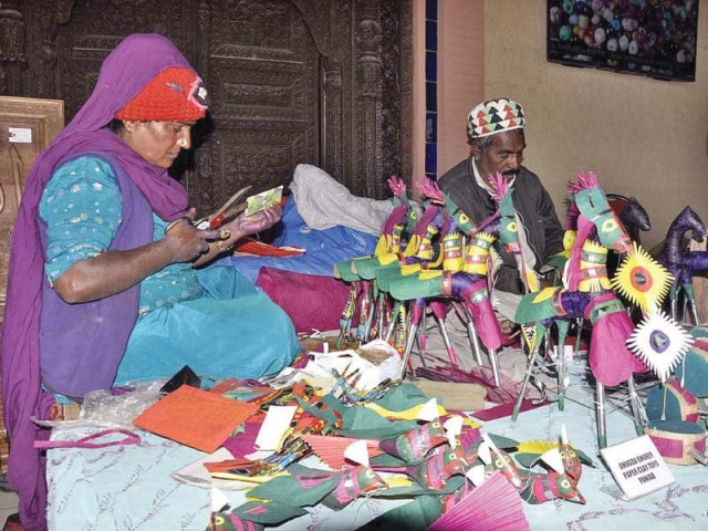 a woman makes paper horses at lok virsa photo app a woman makes paper horses at lok virsa photo app
