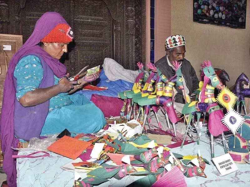 a woman makes paper horses at lok virsa photo app a woman makes paper horses at lok virsa photo app
