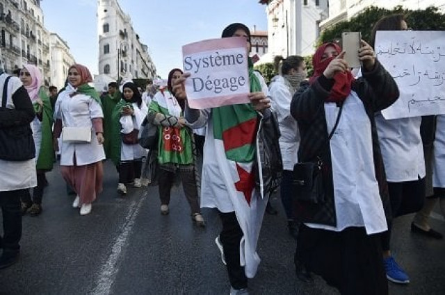 a woman holds a placard reading quot system get off quot as algerian teachers protest in central algiers on march 13 2019 against president abdelaziz bouteflika 039 s bid to prolong his two decade rule photo afp a woman holds a placard reading quot system get off quot as algerian teachers protest in central algiers on march 13 2019 against president abdelaziz bouteflika 039 s bid to prolong his two decade rule photo afp