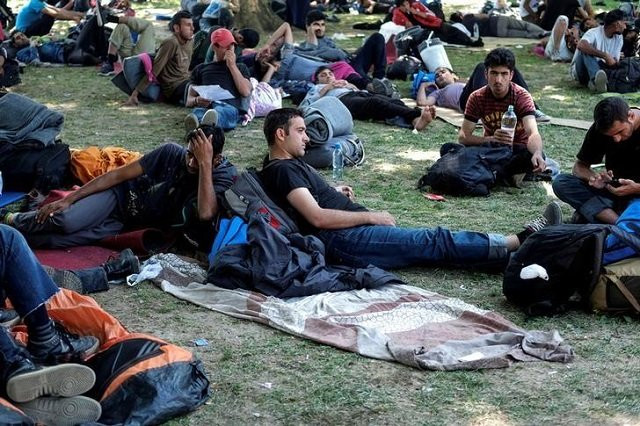 file photo migrants from the middle east and asia rest in a park before they start walking on their way to hungary in belgrade serbia photo reuters file photo migrants from the middle east and asia rest in a park before they start walking on their way to hungary in belgrade serbia photo reuters