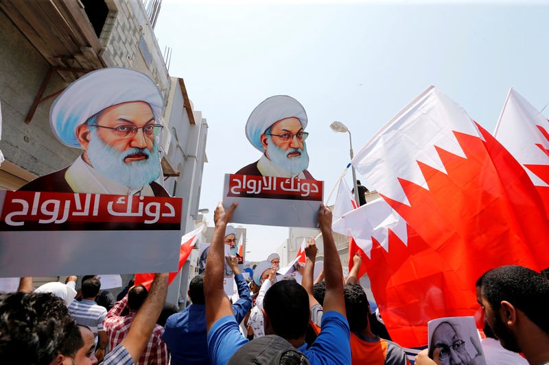 protesters holding bahraini flags and placards with images of bahrain 039 s leading shi 039 ite cleric isa qassim shout religious slogans during an anti government protest after friday prayers in the village of diraz west of manama bahrain august 12 2016 photo reuters