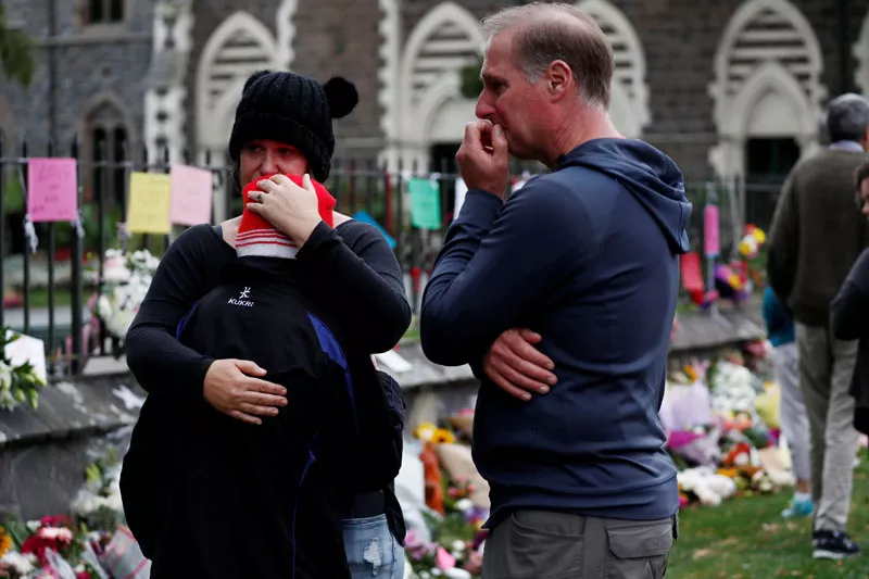 people react at a flower tribute area at botanical gardens in christchurch new zealand photo reuters people react at a flower tribute area at botanical gardens in christchurch new zealand photo reuters
