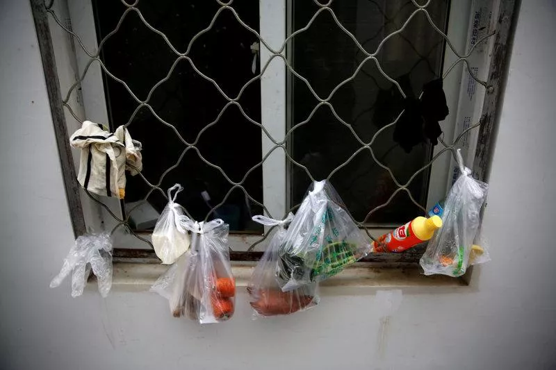 groceries in plastic bags hang by a window photo reuters groceries in plastic bags hang by a window photo reuters