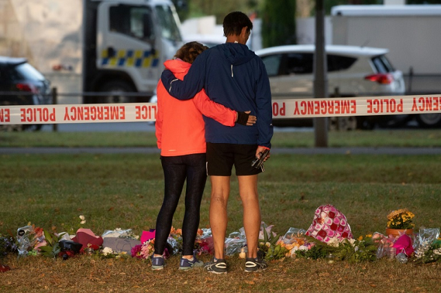 large crowds in christchurch many carrying bouquets of flowers headed to memorials sunday to share messages of love to the victims and their families photo afp