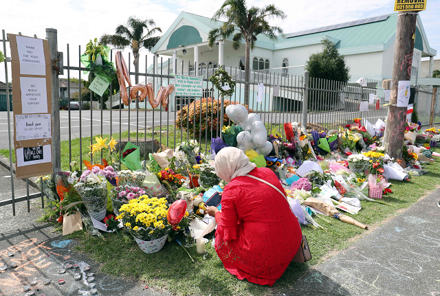 residents pay their respects by placing flowers for the victims of the mosques attacks in christchurch at the masjid umar mosque in auckland on march 17 2019 photo afp