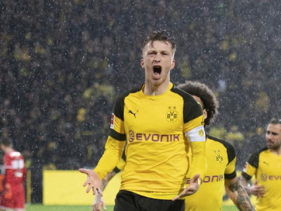 reus sends dortmund top with late winner in berlin