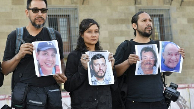 journalists hold up photos of slain colleagues at a rally in mexico city in june 2018 photo afp