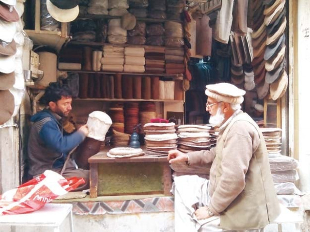 a shopkeeper gives final touches to a pakol photos abdur razzaq a shopkeeper gives final touches to a pakol photos abdur razzaq