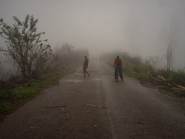 villagers are seen emerging from a mist on march 17 2019 at runhowane settlement approximately 30km from chimanimani manicaland province photo afp