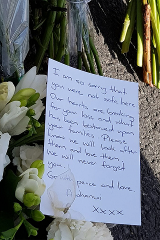 a letter is seen as residents pay their respects by placing flowers for the victims of the mosques attacks in christchurch photo afp a letter is seen as residents pay their respects by placing flowers for the victims of the mosques attacks in christchurch photo afp