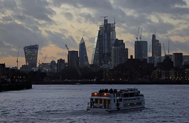 a river boat cruises down the river thames as the sun sets behind the canary wharf financial district of london britain december 7 2018 photo reuters a river boat cruises down the river thames as the sun sets behind the canary wharf financial district of london britain december 7 2018 photo reuters