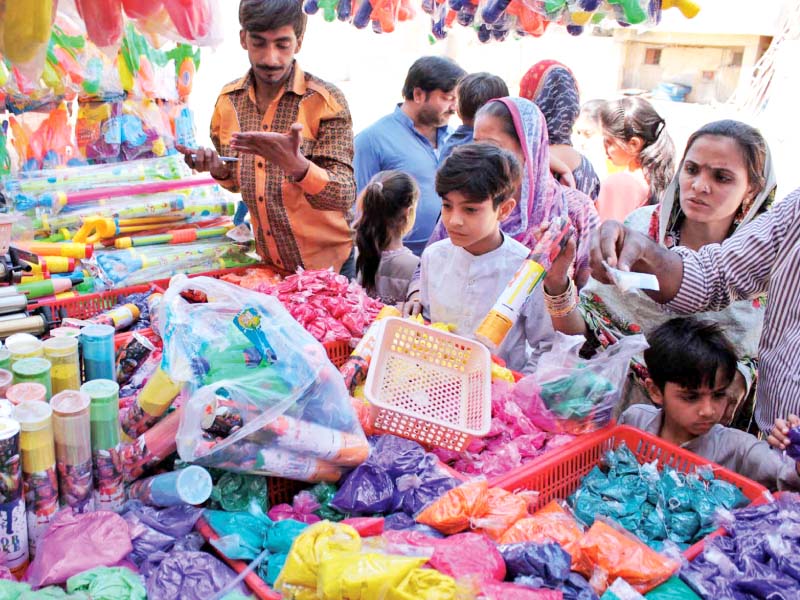 members of the hindu community buy colours at swami narain mandir as part of preparations for holi to be celebrated today photo online