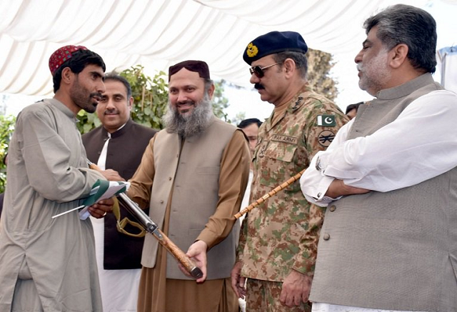 a ferrari hands over his weapon to chief minister jam kamal khan in the garden of the balochistan assembly photo mohammad zafar express