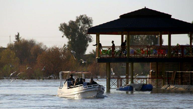 a boat passes the site of a popular mosul picnic area near where the ferry sank on thursday photo afp a boat passes the site of a popular mosul picnic area near where the ferry sank on thursday photo afp