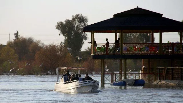a boat passes the site of a popular mosul picnic area near where the ferry sank on thursday photo afp a boat passes the site of a popular mosul picnic area near where the ferry sank on thursday photo afp