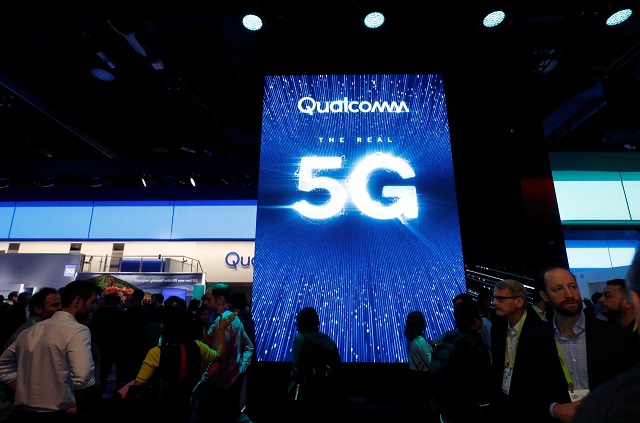 people walk by a video display promoting 5g connectivity at the qualcomm booth during the 2019 ces in las vegas nevada us january 8 2019 photo reuters