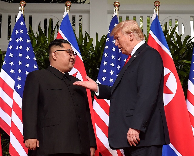 us president donald trump gestures as he meets north korea 039 s leader kim jong un at the start of their historic us north korea summit at the capella hotel on sentosa island in singapore on june 12 2018 photo afp