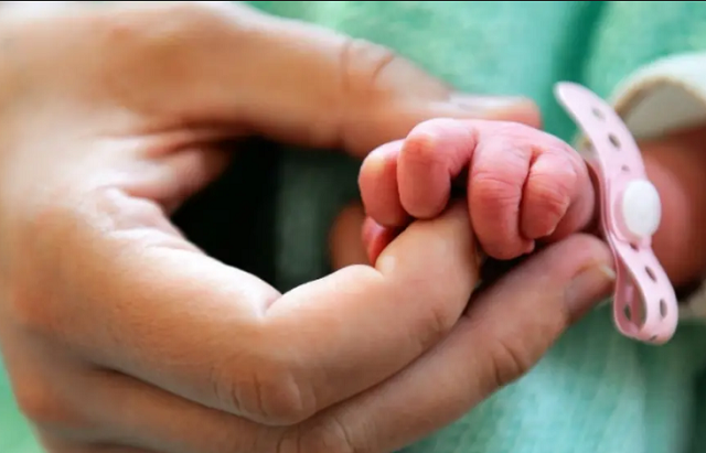 file photo of a mother holding a newborn 039 s hand photo afp