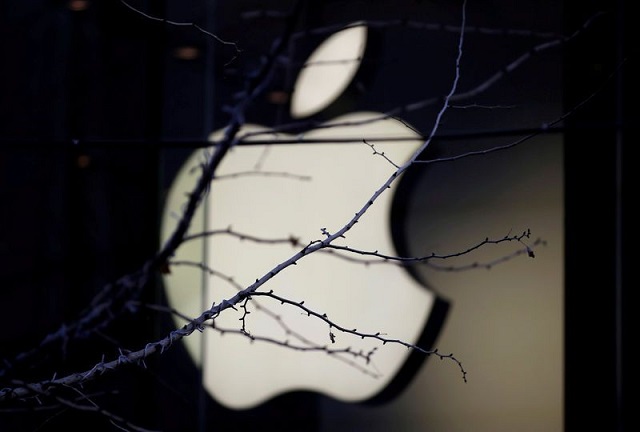 an apple company logo is seen behind tree branches outside an apple store in beijing china december 14 2018 photo reuters