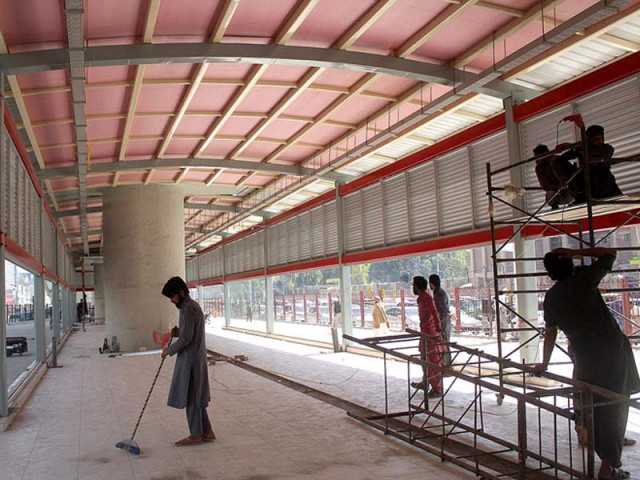 workers giving final touches to a brt station photo inp