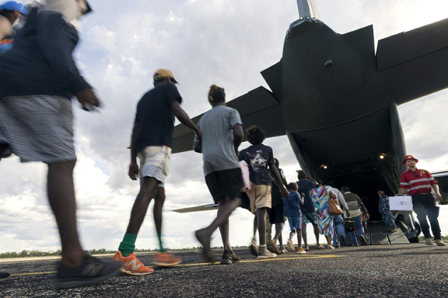 residents of mcarthur river a remote town in the northern territory boarding an australian military plane as authorities evacuate communities in the path of a powerful cyclone photo afp