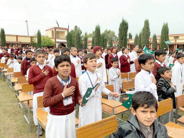 school children recite national anthem while traders distribute sweets in peshawar on pakistan day photos express